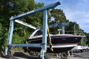 Boat hanging in the sling of the BBYH Marine Travelift